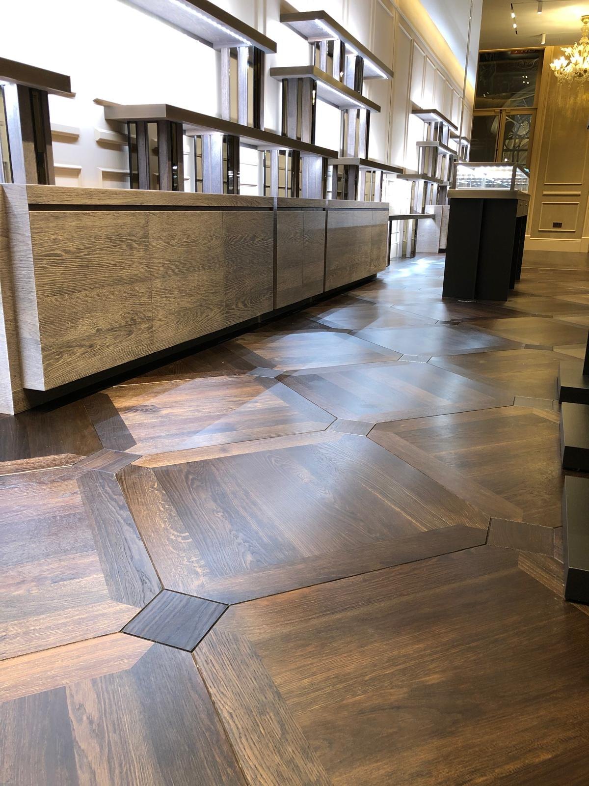 Buccellati — Lit glass display cases against a timber-panelled wall