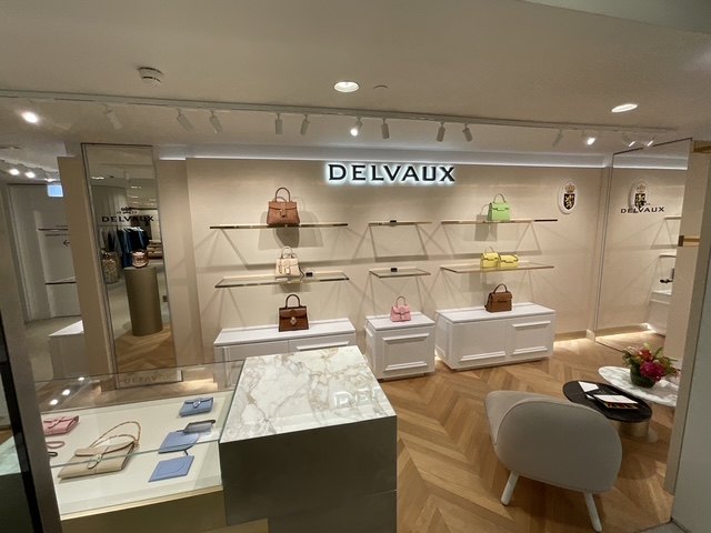 Delvaux — Harrods — Delvaux boutique overview with illuminated signage and display joinery