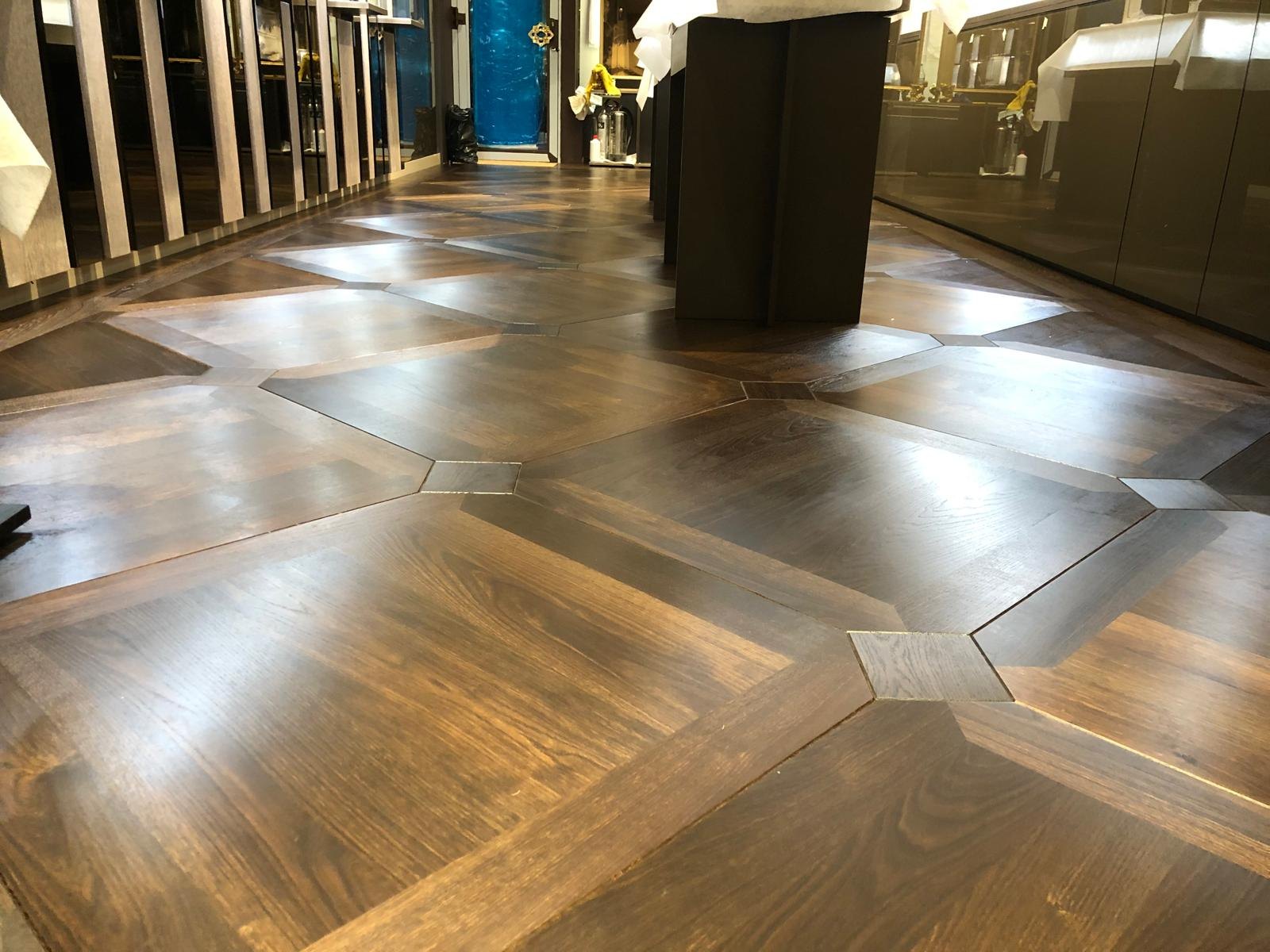 Buccellati — Chandelier display hall with marquetry hardwood flooring