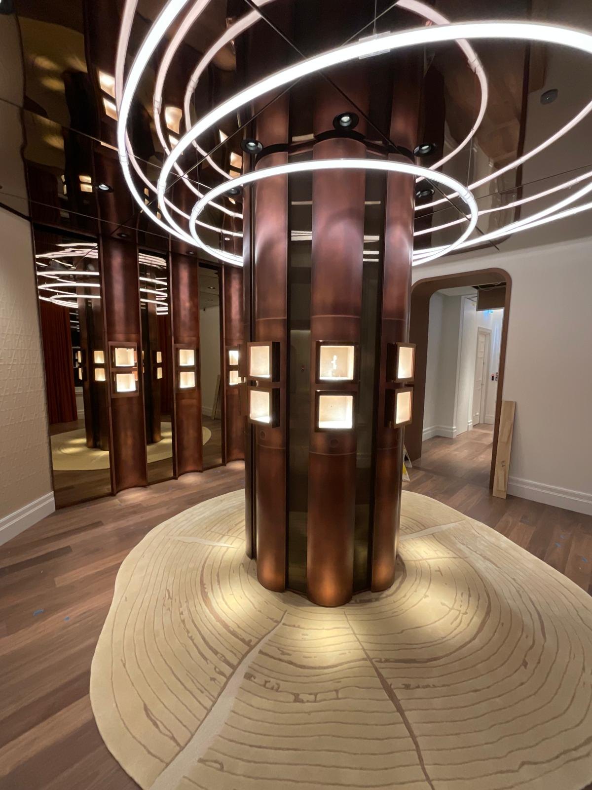 Audemars Piguet — Crescent consultation desk with copper cabinetry